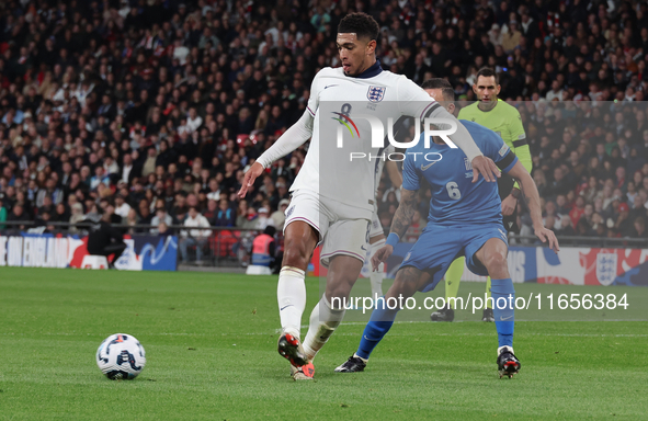 From left to right, Jude Bellingham of Real Madrid and England holds off Dimitris Kourbelis of Al-Khaleej and Greece during the UEFA Nations...