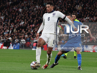 From left to right, Jude Bellingham of Real Madrid and England holds off Dimitris Kourbelis of Al-Khaleej and Greece during the UEFA Nations...