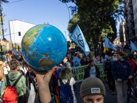 Protesters participate in the climate protest ''Fridays For Future'' in Turin, Italy, on October 11, 2024. The Fridays for the Future moveme...