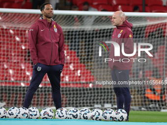 From left to right, Joleon Lescott, interim coach, and Lee Carsley, interim head coach of England, participate in the pre-match warm-up duri...