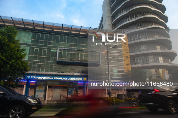 In Medan City, North Sumatra, Indonesia, on October 11, 2024, oil-fueled vehicles pass by an electric fuel filling station during a trial pe...