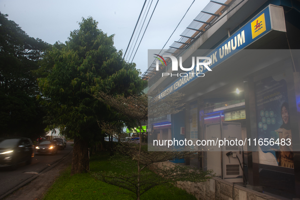 In Medan City, North Sumatra, Indonesia, on October 11, 2024, oil-fueled vehicles pass by an electric fuel filling station during a trial pe...