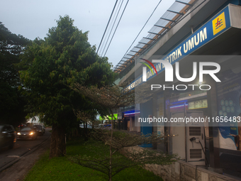 In Medan City, North Sumatra, Indonesia, on October 11, 2024, oil-fueled vehicles pass by an electric fuel filling station during a trial pe...