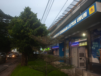 In Medan City, North Sumatra, Indonesia, on October 11, 2024, oil-fueled vehicles pass by an electric fuel filling station during a trial pe...