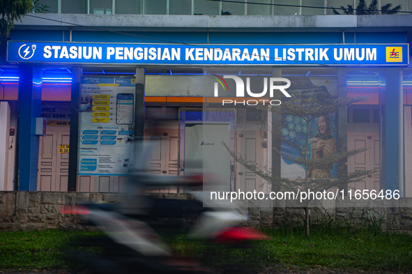 In Medan City, North Sumatra, Indonesia, on October 11, 2024, oil-fueled vehicles pass by an electric fuel filling station during a trial pe...