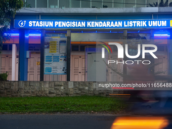 In Medan City, North Sumatra, Indonesia, on October 11, 2024, oil-fueled vehicles pass by an electric fuel filling station during a trial pe...