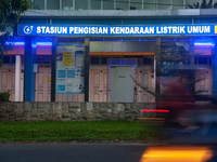 In Medan City, North Sumatra, Indonesia, on October 11, 2024, oil-fueled vehicles pass by an electric fuel filling station during a trial pe...