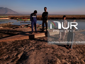 Kashmiri boys visit Wular Lake as a sightseeing location in Sopore, Jammu and Kashmir, India, on October 11, 2024. (