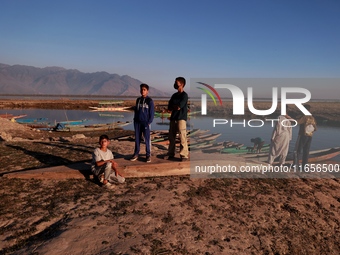 Kashmiri boys visit Wular Lake as a sightseeing location in Sopore, Jammu and Kashmir, India, on October 11, 2024. (