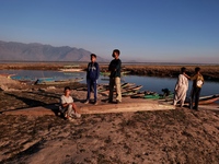 Kashmiri boys visit Wular Lake as a sightseeing location in Sopore, Jammu and Kashmir, India, on October 11, 2024. (