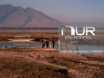 Kashmiri boys visit Wular Lake as a sightseeing location in Sopore, Jammu and Kashmir, India, on October 11, 2024. (