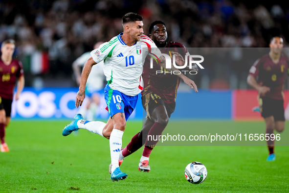 Lorenzo Pellegrini of Italy and Orel Mangala of Belgium compete for the ball during the UEFA Nations League 2024/25 League A Group A2 match...