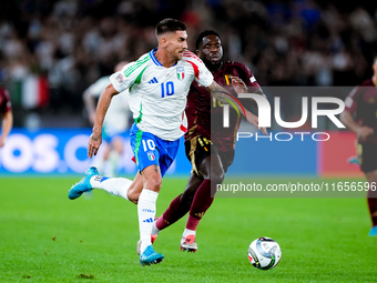 Lorenzo Pellegrini of Italy and Orel Mangala of Belgium compete for the ball during the UEFA Nations League 2024/25 League A Group A2 match...