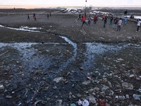 Kashmiri boys play volleyball as garbage is seen all around on the banks of Wular Lake in Sopore, Jammu and Kashmir, India, on October 11, 2...