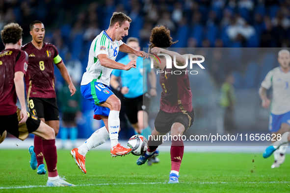 Davide Frattesi of Italy and Arthur Theate of Belgium compete for the ball during the UEFA Nations League 2024/25 League A Group A2 match be...