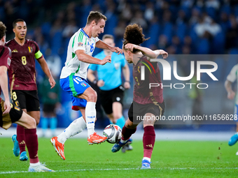 Davide Frattesi of Italy and Arthur Theate of Belgium compete for the ball during the UEFA Nations League 2024/25 League A Group A2 match be...