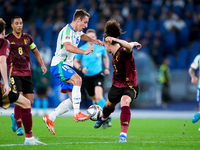 Davide Frattesi of Italy and Arthur Theate of Belgium compete for the ball during the UEFA Nations League 2024/25 League A Group A2 match be...