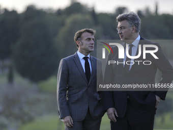 France's President Emmanuel Macron, left, and Prime Minister of Croatia Andrej Plenkovic talk on the sidelines of the MED9 leaders' summit a...