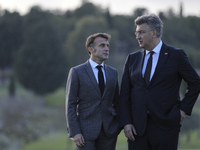 France's President Emmanuel Macron, left, and Prime Minister of Croatia Andrej Plenkovic talk on the sidelines of the MED9 leaders' summit a...