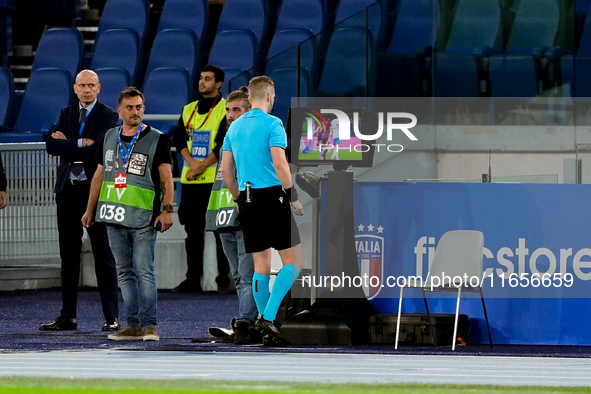 Referee Espen Eskas consults the pitch-side monitor after advice from the VAR during the UEFA Nations League 2024/25 League A Group A2 match...