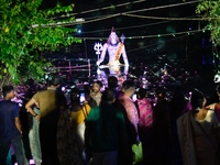 A statue of the Hindu deity Shiva is illuminated at night during the Durga Puja religious festival near a Puja Mandap in Dhaka, Bangladesh,...