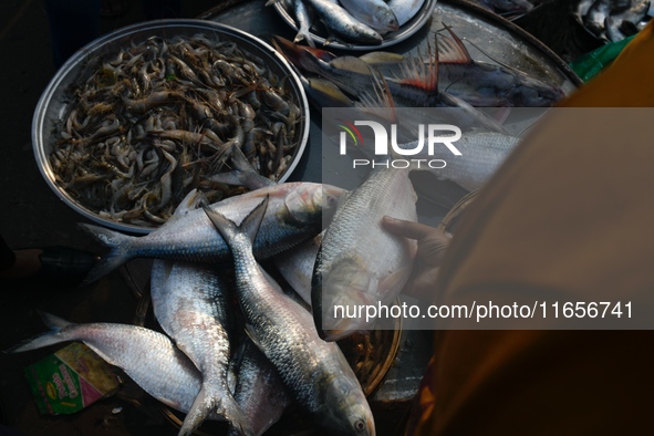 Traders exchange Hilsa fish at a wholesale fish market early in the morning near the Padma River in Mawa, Munshiganj, Bangladesh, on October...