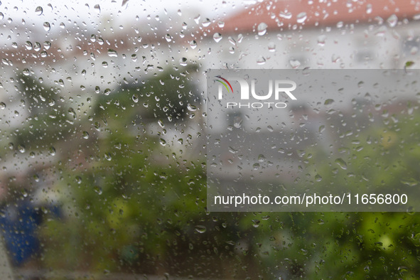 Raindrops are on a window during heavy rains in Lisbon, Portugal, on October 11, 2024. The national emergency and Civil Protection authority...