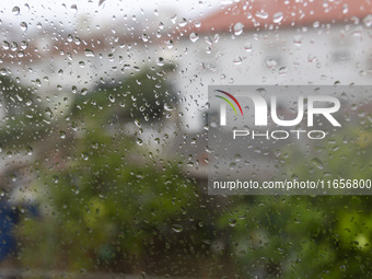 Raindrops are on a window during heavy rains in Lisbon, Portugal, on October 11, 2024. The national emergency and Civil Protection authority...