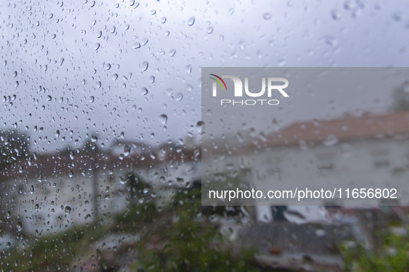 Raindrops are on a window during heavy rains in Lisbon, Portugal, on October 11, 2024. The national emergency and Civil Protection authority...