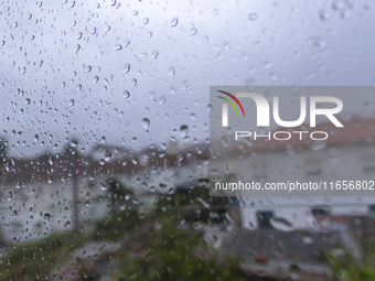 Raindrops are on a window during heavy rains in Lisbon, Portugal, on October 11, 2024. The national emergency and Civil Protection authority...