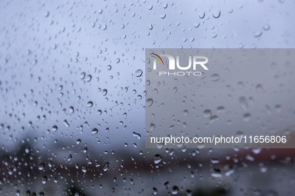 Raindrops are on a window during heavy rains in Lisbon, Portugal, on October 11, 2024. The national emergency and Civil Protection authority...