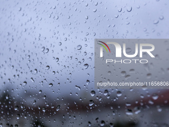 Raindrops are on a window during heavy rains in Lisbon, Portugal, on October 11, 2024. The national emergency and Civil Protection authority...