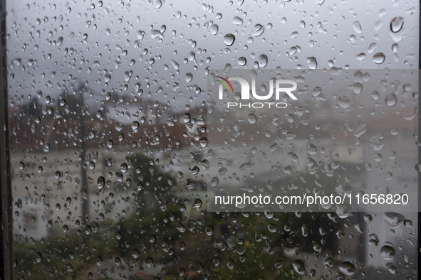 Raindrops are on a window during heavy rains in Lisbon, Portugal, on October 11, 2024. The national emergency and Civil Protection authority...