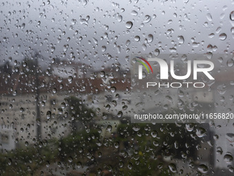 Raindrops are on a window during heavy rains in Lisbon, Portugal, on October 11, 2024. The national emergency and Civil Protection authority...