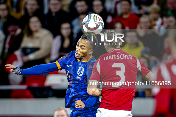 Netherlands midfielder Quinten Timber and Hungary midfielder Tamas Nikitscher play during the match between Hungary and the Netherlands at t...