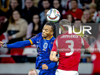 Netherlands midfielder Quinten Timber and Hungary midfielder Tamas Nikitscher play during the match between Hungary and the Netherlands at t...