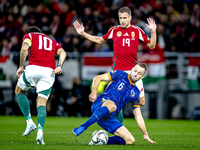 Hungary midfielder Dominik Szoboszlai, Netherlands defender Stefan de Vrij, and Hungary forward Barnabas Varga participate in the match betw...