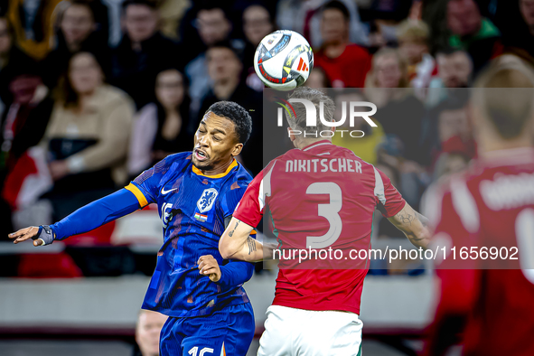 Netherlands midfielder Quinten Timber and Hungary midfielder Tamas Nikitscher play during the match between Hungary and the Netherlands at t...