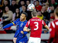 Netherlands midfielder Quinten Timber and Hungary midfielder Tamas Nikitscher play during the match between Hungary and the Netherlands at t...