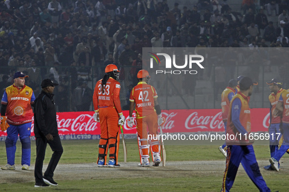 Chris Gayle (L) and Shikhar Dhawan (R) of Gujarat Greats participate in the Legends League Cricket T20 match between Gujarat Greats and Kona...