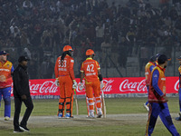 Chris Gayle (L) and Shikhar Dhawan (R) of Gujarat Greats participate in the Legends League Cricket T20 match between Gujarat Greats and Kona...