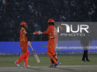 Chris Gayle (R) and Shikhar Dhawan (L) of Gujarat Greats participate in the Legends League Cricket T20 match between Gujarat Greats and Kona...