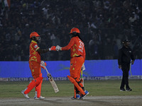 Chris Gayle (R) and Shikhar Dhawan (L) of Gujarat Greats participate in the Legends League Cricket T20 match between Gujarat Greats and Kona...