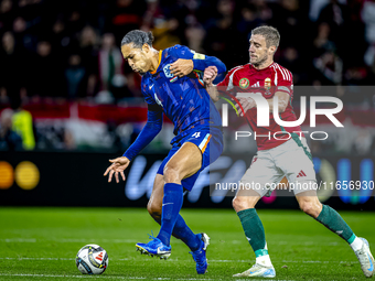 Netherlands defender Virgil van Dijk and Hungary forward Barnabas Varga play during the match between Hungary and the Netherlands at the Pus...