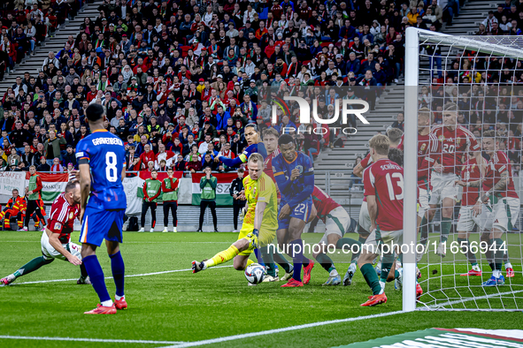 Scimmige scores a goal against Hungary goalkeeper Denes Dibusz during the match between Hungary and the Netherlands at the Puskas Arena for...