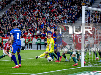 Scimmige scores a goal against Hungary goalkeeper Denes Dibusz during the match between Hungary and the Netherlands at the Puskas Arena for...