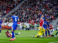 Scimmige scores a goal against Hungary goalkeeper Denes Dibusz during the match between Hungary and the Netherlands at the Puskas Arena for...