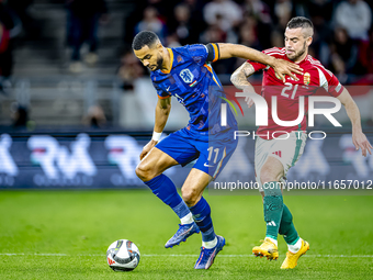 Netherlands forward Cody Gakpo and Hungary defender Endre Botka play during the match between Hungary and the Netherlands at the Puskas Aren...