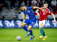 Netherlands forward Cody Gakpo and Hungary defender Endre Botka play during the match between Hungary and the Netherlands at the Puskas Aren...