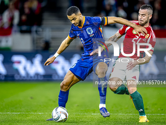 Netherlands forward Cody Gakpo and Hungary defender Endre Botka play during the match between Hungary and the Netherlands at the Puskas Aren...